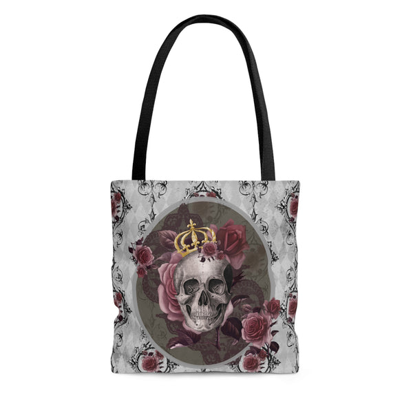Tote bag with black handle and design of a gray skull with gold crown and roses on a gray background with back scroll lines and burgundy flowers