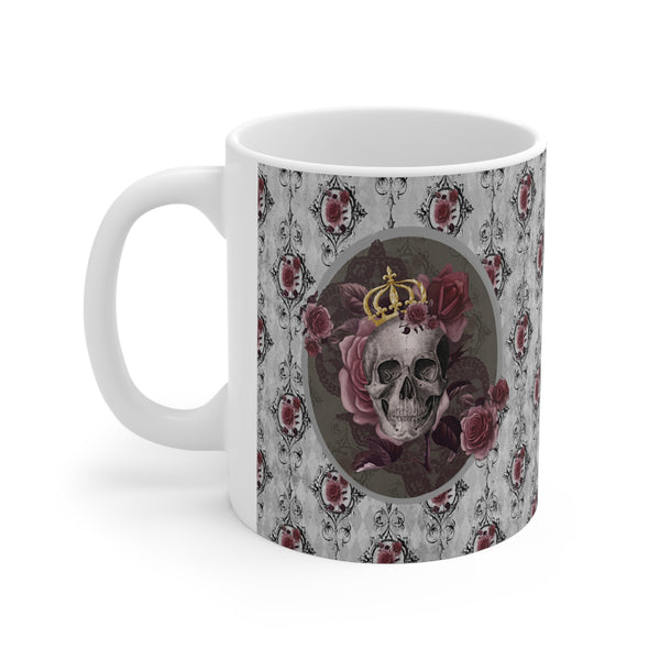 Ceramic mug with a skull wearing a gold crown accented with burgundy roses inside an oval with a light gray border, on a background of gray with black scrolls and burgundy roses with white handle.