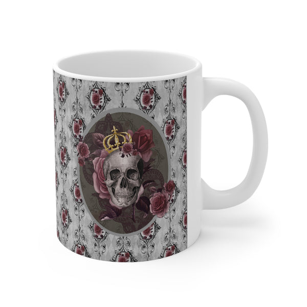 Ceramic mug with a skull wearing a gold crown accented with burgundy roses inside an oval with a light gray border, on a background of gray with black scrolls and burgundy roses with white handle.