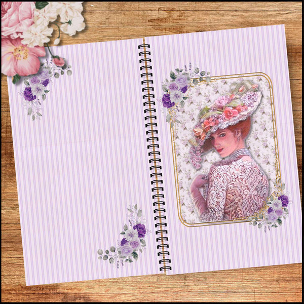 A spiral-bound notebook or journal shown open on a wooden surface, with pale pink and white vertical stripes on the pages. The right page features a decorative floral border and a vintage-style portrait framed in gold.