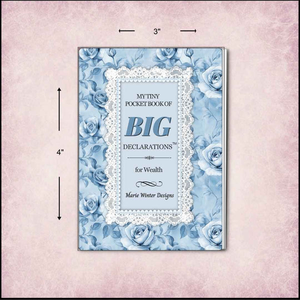 A small pocket book with a floral cover design, shown with dimension arrows indicating 3 inches wide by 4 inches tall. The cover features blue roses, a white lace border, and the title 'My Tiny Pocket Book of Big Declarations for Wealth' by Marie Winter Designs.