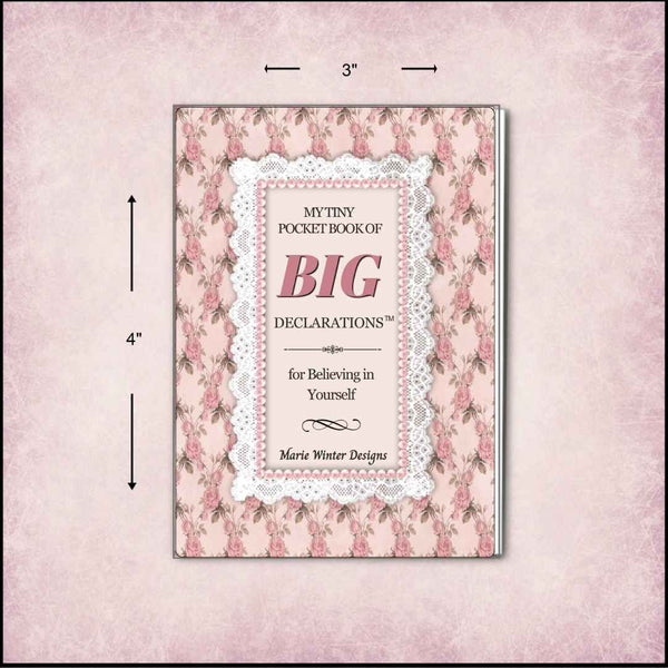 A pink floral pocket book with a lace-trimmed title panel reading 'My Tiny Pocket Book of Big Declarations' and 'for Believing in Yourself' by Marie Winter Designs. Black dimension arrows and labels indicate 3 inches wide by 4 inches tall, shown on a pale pink textured background.