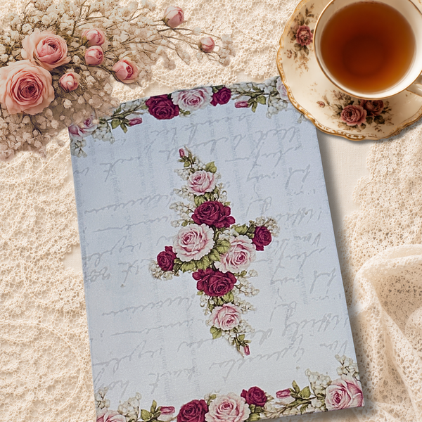 Back side of the letter featuring pink and burgundy roses arranged in a cross design, displayed on a cream lace background beside a vintage teacup filled with tea.