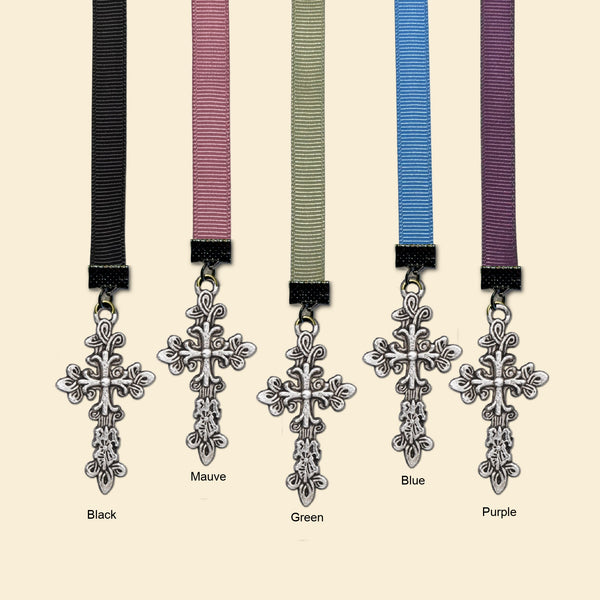 Five ribbon bookmarks with ornate silver cross charms are shown on a light beige background, labeled Black, Mauve, Green, Blue, and Purple.