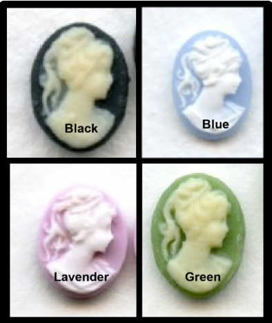 Four oval cameo-style beads or cabochons shown in a 2x2 grid, each labeled with a color name: Black, Blue, Lavender, and Green. The beads feature a raised classical profile design in a light cream tone against a dark or pastel background.