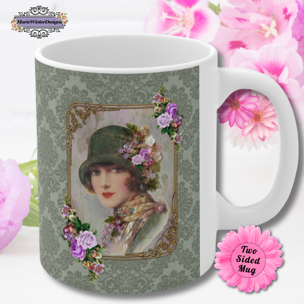 Ceramic Mug With Elegant 1920s Vintage Woman in Green Flapper Style Gatsby Hat surrounded by a gold art deco style frame accented with vintage purple flowers on green damask background with white handle. Pink flowers are behind the mug. Two sided mug. Stack of cookies and flowers are behind the mug.