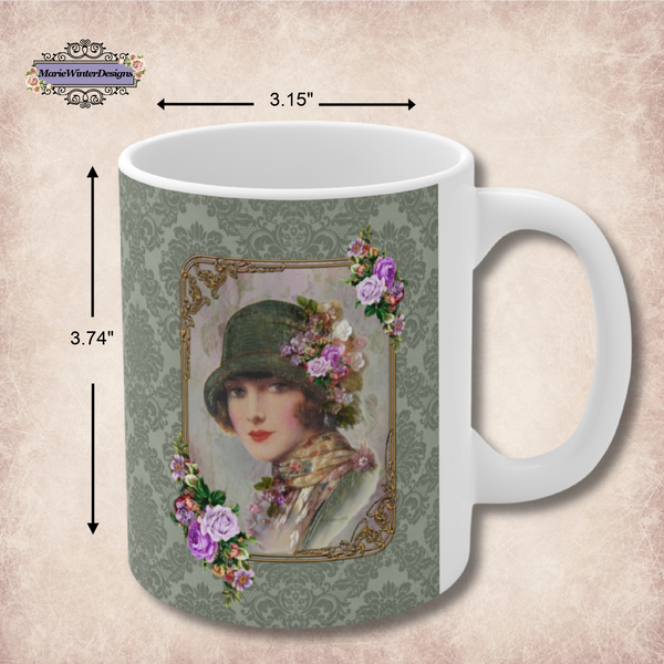 Measurements of a Ceramic Mug With Elegant 1920s Vintage Woman in Green Flapper Style Gatsby Hat surrounded by a gold art deco style frame accented with vintage purple flowers on green damask background with white handle.