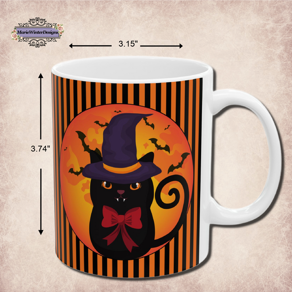 Measurements of a  Halloween mug with black cat wearing a purple pointed had and a red bow around neck in side a circle with bats flying behind on an orange and black stripe background with a white handle