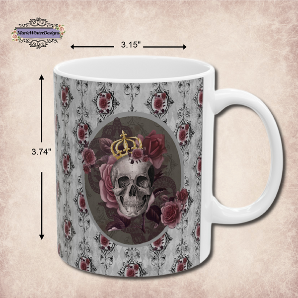 measurements of Ceramic mug with a skull wearing a gold crown accented with burgundy roses inside an oval with a light gray border, on  a background of gray with black scrolls and burgundy roses with a white handle