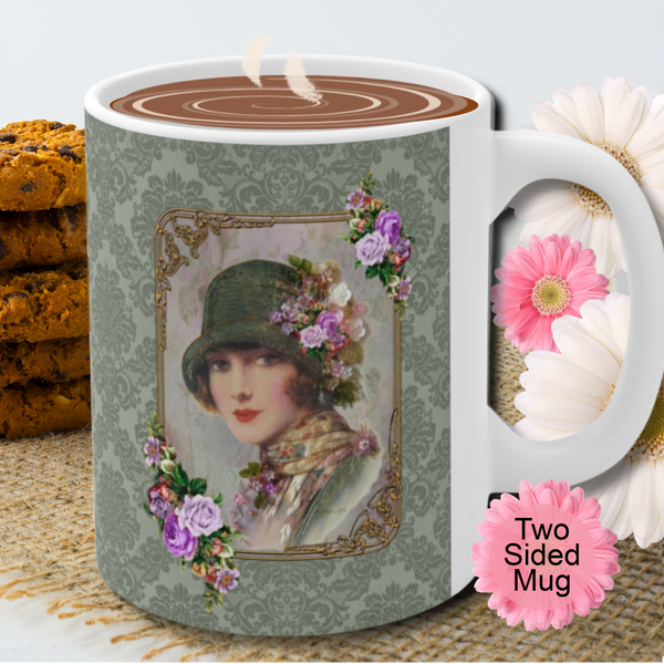 Ceramic Mug With Elegant 1920s Vintage Woman in Green Flapper Style Gatsby Hat surrounded by a gold art deco style frame accented with vintage purple flowers on green damask background with white handle. Pink flowers are behind the mug. Two sided mug. Stack of cookies and flowers are behind the mug.