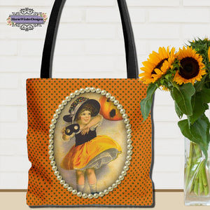 Vintage-inspired Halloween tote bag featuring an illustration of a young girl in a witch costume, framed with pearls on a polka dot orange background, with a vase of sunflowers nearby