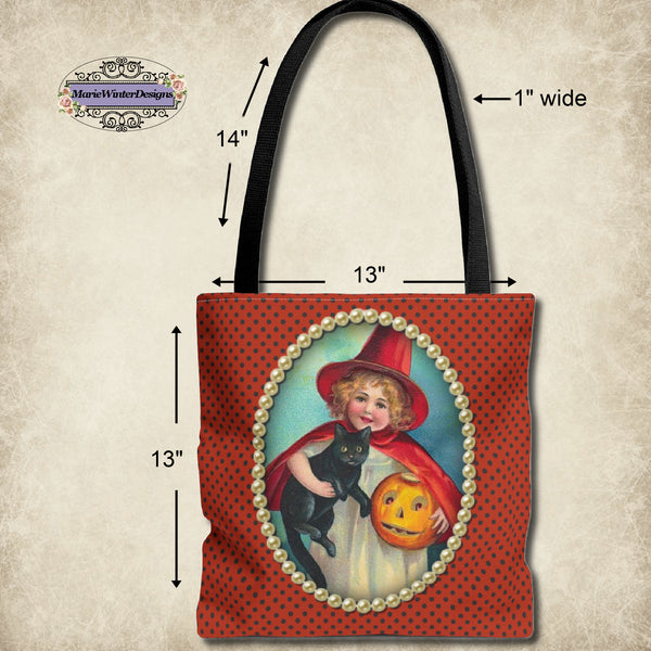 measurements of  A Halloween-themed tote bag featuring a vintage-style illustration of a young girl in a red witch costume holding a black cat and a jack-o-lantern, framed by pearls on a polka-dot orange background.