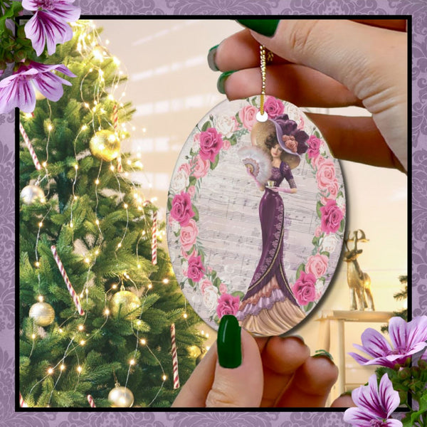 Oval ceramic ornament with Edwardian Lady with large hat music sheet background surrounded with pink and white roses in front of Christmas tree