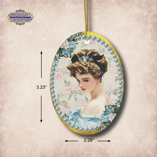 Measurements of Ceramic Ornament With Elegant Early 1900s Vintage Harrison Fisher Illustration of Lady with Blue Flowers Surrounded with Blue Pearls. 3.23" x 2.28"
