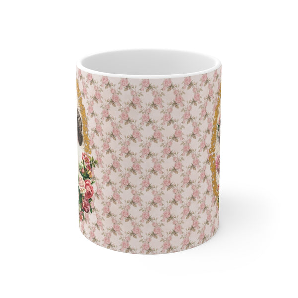 side view of mug with pink roses and green leaves on white background