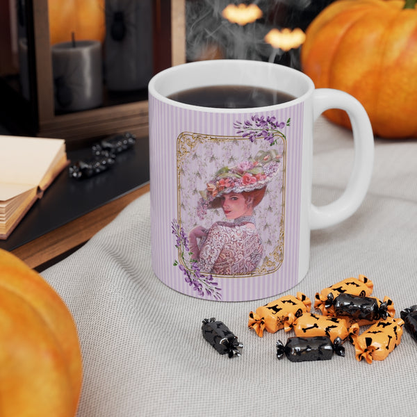 Ceramic Mug with Elegant Early 1900s Vintage Woman wearing  a Purple Lace Dress, Large Floral Hat Purple on Striped Background and White Handle. A pumpkin is in the background and Halloween candy is in front.