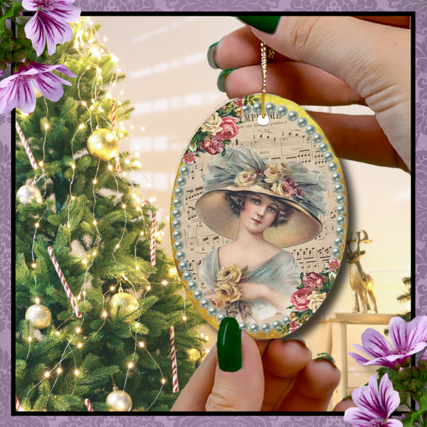 ceramic orament with vintage lady in teal dress and large hat surrounded by teal pearls with pink roses to the side with Christmas tree