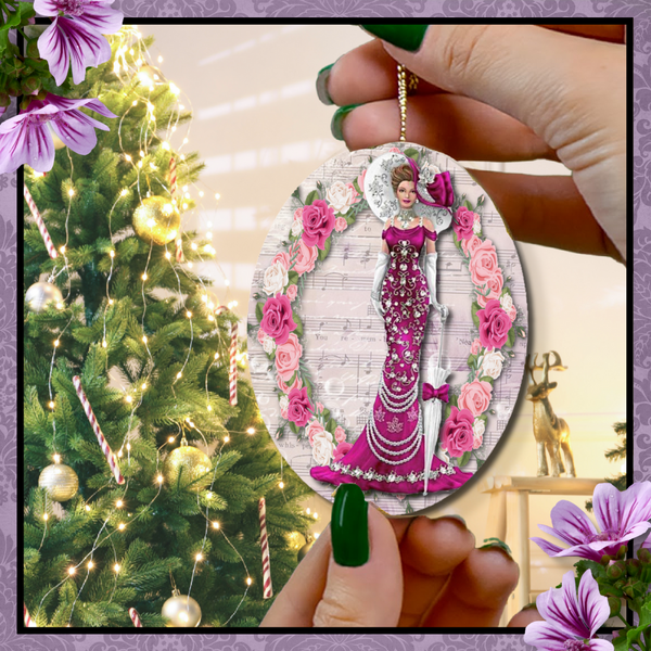 Hands with green nail polish holding an oval Oval ceramic ornament with Edwardian Lady with large hat music sheet background surrounded with pink and white roses in front of Christmas tree