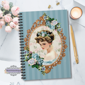 Spiral Bound Notebook Journal With  Early 1900s Vintage Harrison Fisher Illustration of Lady In Gold Frame Accented With Roses with candle, gold pen and pink roses behind